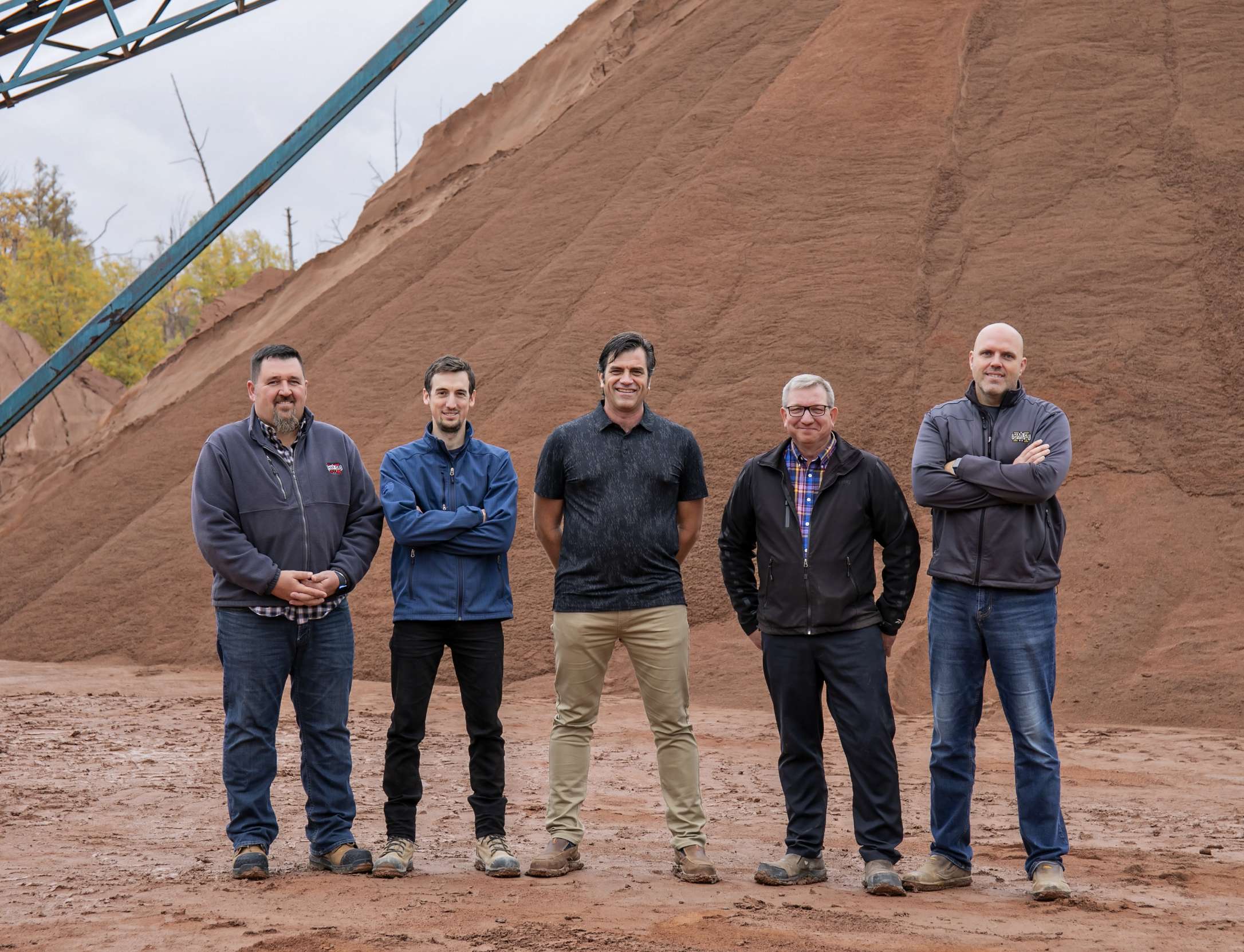The Mar-Co Clay team standing on a mound of clay